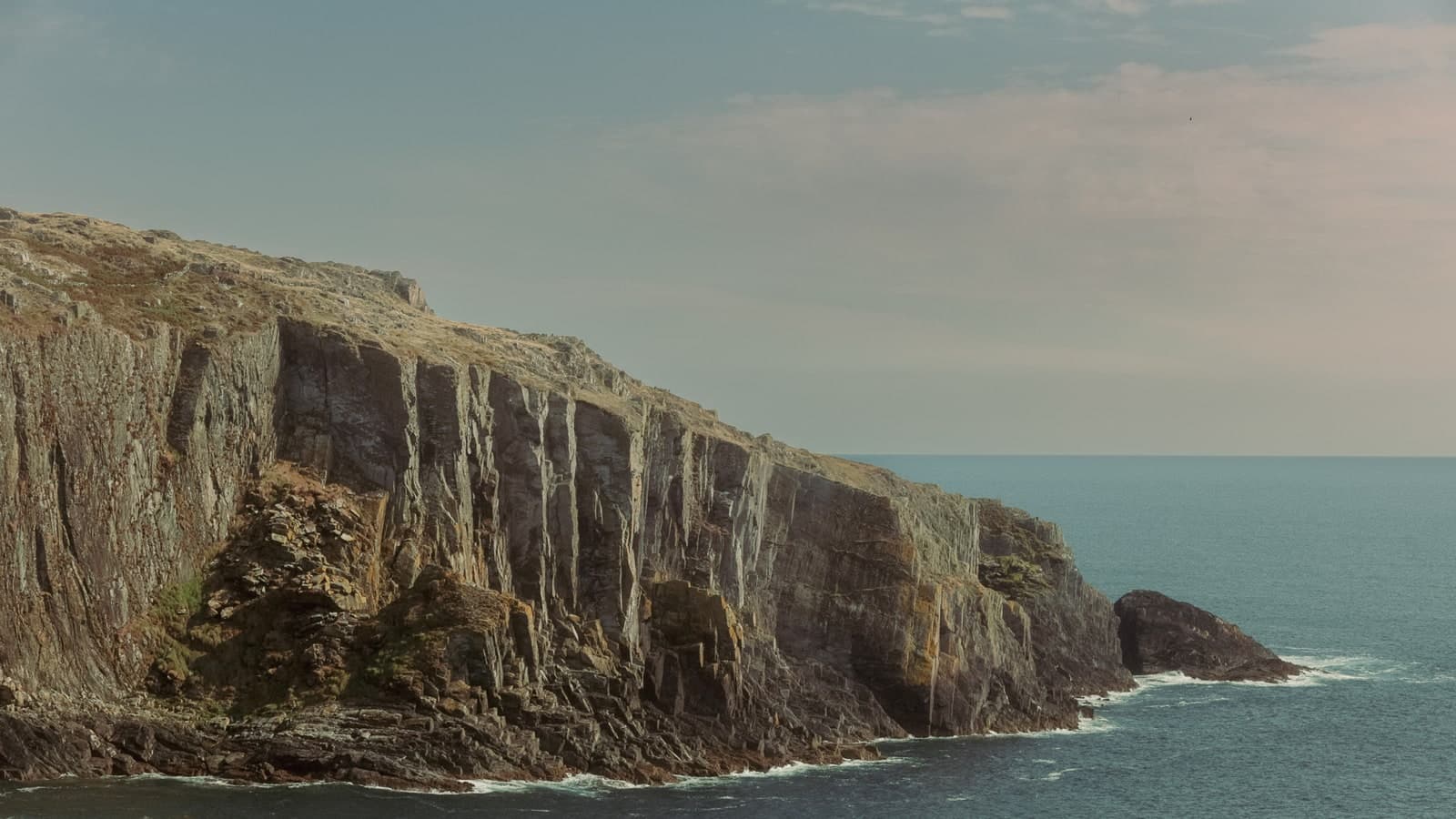 Sea cliffs on the Irish coast under a soft evening sky